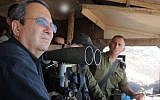 Defence Minister Ehud Barak visits the IDF Northern Command Unit on the Golan Heights, near Syria, July 19, 2012. Images of Barak observing a a battle between the Syrian Army and rebel forces has prompted a wave of sight-seers looking for action. (photo credit: Minisry of Defence/FLASH90)
