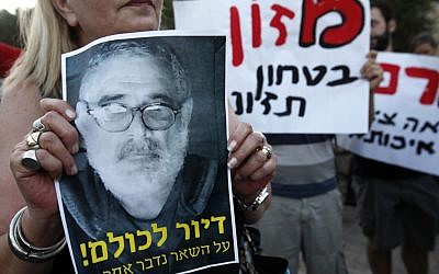 Social justice protesters chant slogans as they hold up pictures of Moshe Silman, who set himself on fire during a social justice demonstration in Tel Aviv (photo credit: Miriam Alster/Flash90)