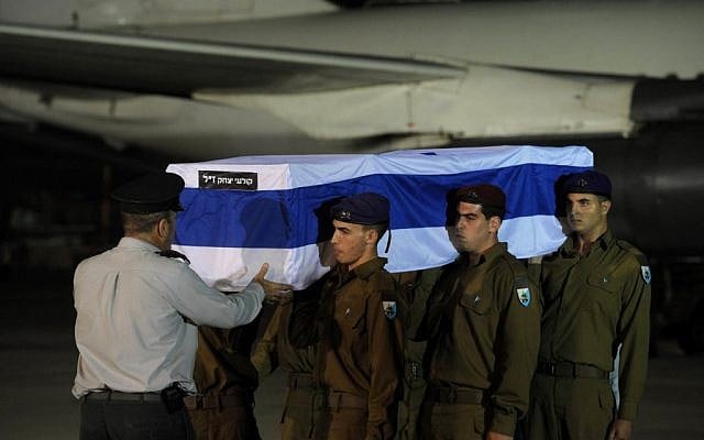 Soldiers unload the coffin of Itzik Kolengi, 28, who was killed in a suicide bombing in Bulgaria on Wednesday, at an official ceremony at Ben-Gurion Airport outside Tel Aviv late Thursday night. (photo credit: Amos Ben Gershom/GPO/Flash90)