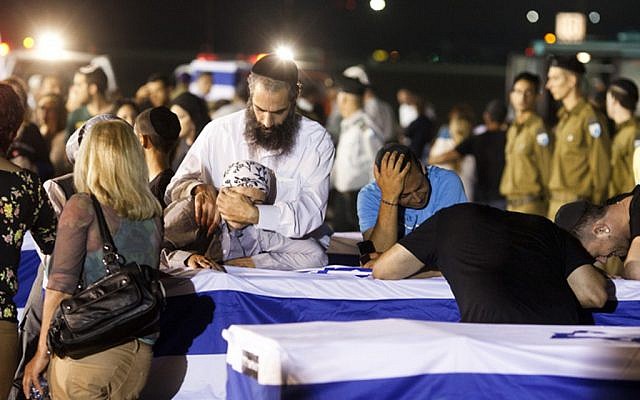 Family and friends mourn over the coffin of one of the victims of the suicide bombing in Bulgaria, as the bodies arrived at the Ben-Gurion Airport early Friday morning. (photo credit: Tali Mayer/Flash90) Family and friends mourn over the coffin of one of the victims of the suicide bombing in Bulgaria, as the bodies arrived at the Ben-Gurion Airport early Friday morning. (photo credit: Tali Mayer/Flash90)