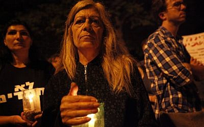 An Israeli woman holds a candle at a memorial march for Moshe Silman (photo credit: Miriam Alster/FLASH90)