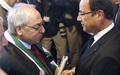 French President Francois Hollande (right) shakes hands with the leader of the Syrian National Council Abdulbaset Sieda during the Friends of Syria conference in Paris Friday. (photo credit: Patrick Kovarik/AP) French President Francois Hollande (right) shakes hands with the leader of the Syrian National Council Abdulbaset Sieda during the Friends of Syria conference in Paris Friday. (photo credit: Patrick Kovarik/AP)