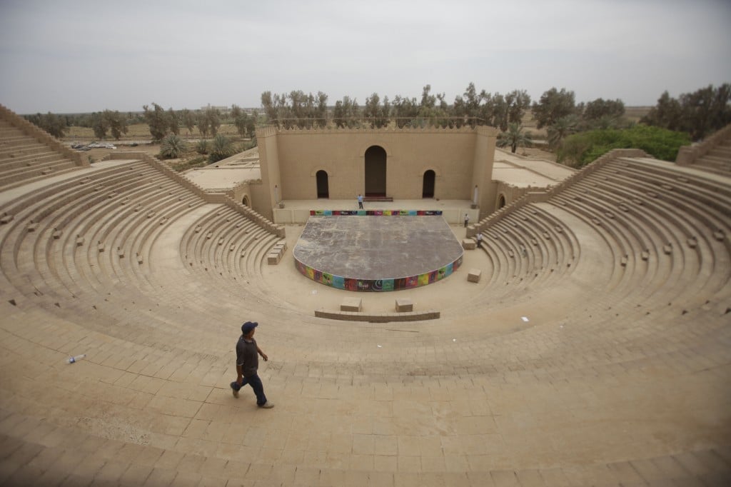 A man walks through an amphitheater at the archaeological site of Babylon. (photo credit: AP Photo/Khalid Mohammed)