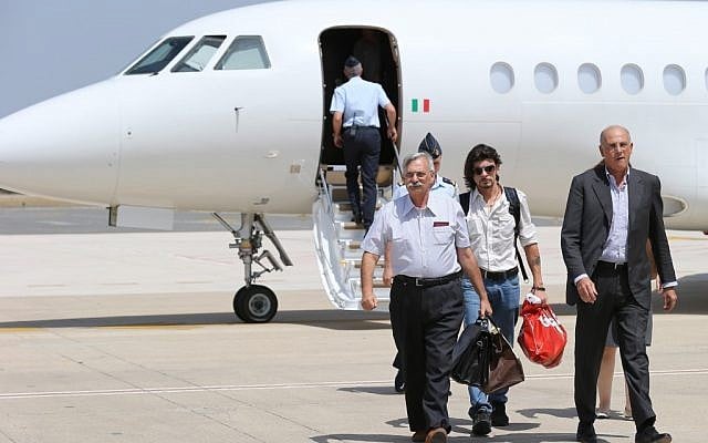 Two Italian electrical engineers, Oriano Cantani, 64, left, and Domenico Tedeschi, 36,center, arrive at Rome's Ciampino military airport Sunday, July 29, 2012. (photo credit: AP/Gregorio Borgia)