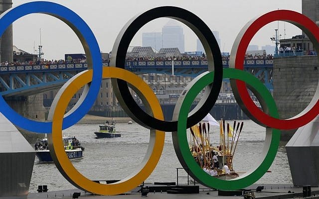 The royal barge Gloriana carries the Olympic flame along the river Thames, ahead of the 2012 Summer Olympics, on the final day of the Torch Relay, Friday, July 27 (photo credit: AP/Kirsty Wigglesworth)