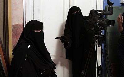 Ameera Essa, center, directs colleagues at the Maria Channel as they prepare to film a segment of a Ramadan program at their studio in Cairo on Monday, July 23, 2012. (photo credit: Maya Alleruzzo/AP)