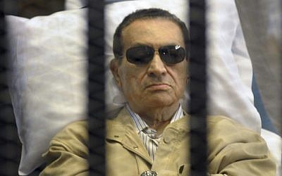 Egypt's ex-President Hosni Mubarak lays on a gurney inside a barred cage in the police academy courthouse in Cairo, Egypt, June 2012 (photo credit: AP)