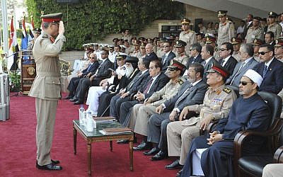 An Egyptian officer salutes Mohammed Morsi during a graduation ceremony Monday (photo credit: (AP Photo/Sheriff Abd El Monem)