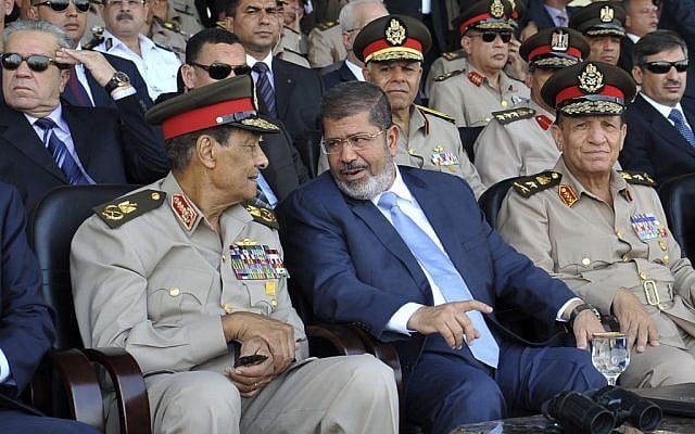 Egyptian President Morsi (center) and General Tantawi attend a military graduation ceremony on July 17 (photo credit: AP Photo/Sheriff Abd El Minoem) Egyptian President Morsi (center) and General Tantawi attend a military graduation ceremony on July 17 (photo credit: AP Photo/Sheriff Abd El Minoem)