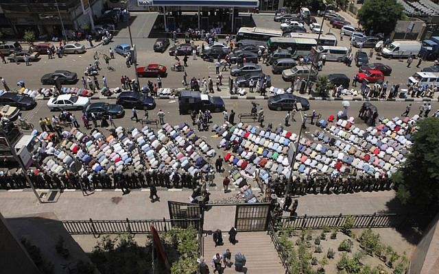 Islamists praying outside a courthouse in Cairo Tuesday. (photo credit: AP/Amr Nabil)