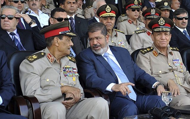 Mohammed Morsi (center) talks with Field Marshal Hussein Tantawi (photo credit:Sheriff Abd El Minoem, Egyptian Presidency/AP) Mohammed Morsi (center) talks with Field Marshal Hussein Tantawi (photo credit:Sheriff Abd El Minoem, Egyptian Presidency/AP)