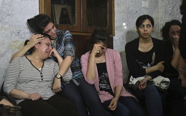Palestinian Christians cry during a rally against the forced conversions of two individuals. (photo credit: AP/Adel Hana) Palestinian Christians cry during a rally against the forced conversions of two individuals. (photo credit: AP/Adel Hana)