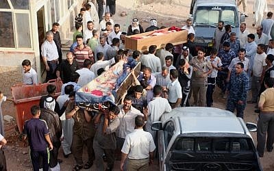 Bombing victims are taken for burial in Najaf, 100 miles south of Baghdad, Iraq, on Tuesday, July 3, 2012. (photo credit: Alaa al-Marjani/AP)