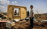 Illustrative: members of the Hilltop Youth try to rebuild a structure demolished by Israeli troops in the West Bank outpost of Maoz Esther, a hilltop site northeast of Ramallah, in May 2009. (Sebastian Scheiner/AP)