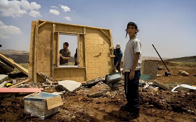 Illustrative: members of the Hilltop Youth try to rebuild a structure demolished by Israeli troops in the West Bank outpost of Maoz Esther, a hilltop site northeast of Ramallah, in May 2009. (Sebastian Scheiner/AP) Illustrative: members of the Hilltop Youth try to rebuild a structure demolished by Israeli troops in the West Bank outpost of Maoz Esther, a hilltop site northeast of Ramallah, in May 2009. (Sebastian Scheiner/AP)