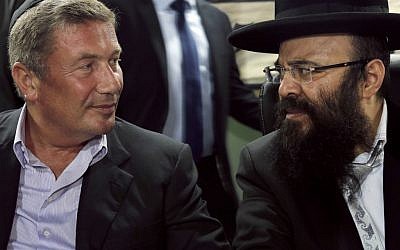 Rabbi Yaakov Israel Ifargan, right, known as the 'X-Ray' rabbi sits next to businessman Nochi Dankner at the annual gathering of the rabbi's followers and supporters in the town of Netivot, on July 1 (photo credit: AP/Tsafrir Abayov)