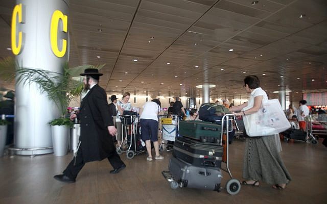 Israelis move through the departure terminal at Ben-Gurion International Airport in Tel Aviv Thursday, July 19, 2012.  (photo credit:AP/Dan Balilty)