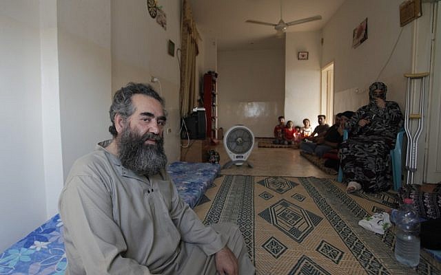 Abo Manar Ahmed Abazeed, 48, and his family from Tal Shehab city in Syria, are seen in their temporary home in Irbid, Jordan on Tuesday (photo credit: AP/Mohammad Hannon) Abo Manar Ahmed Abazeed, 48, and his family from Tal Shehab city in Syria, are seen in their temporary home in Irbid, Jordan on Tuesday (photo credit: AP/Mohammad Hannon)