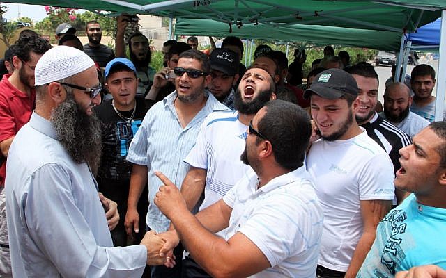Sheik Ahmad Assir, left, receives a group of supporters in the southern port city of Sidon, Lebanon, on Sunday (photo credit: AP/Bilal Hussein) Sheik Ahmad Assir, left, receives a group of supporters in the southern port city of Sidon, Lebanon, on Sunday (photo credit: AP/Bilal Hussein)