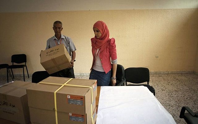 Libyan election officials setting up a polling station in Tripoli on Friday (photo credit: AP/Manu Brabo) Libyan election officials setting up a polling station in Tripoli on Friday (photo credit: AP/Manu Brabo)