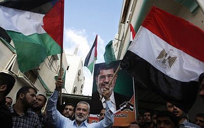 Hamas Prime Minister Ismail Haniyeh celebrates the victory of Mohammed Morsi in Egypt in June (photo credit: AP/Hatem Moussa)
