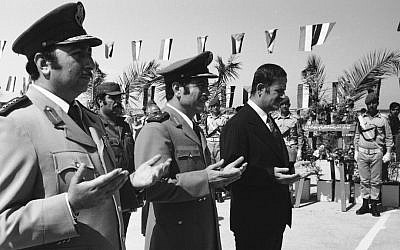This photo from 1974 shows then Syrian president Hafez Assad (right) and war minister, and father of Manaf Tlas, Gen. Mustafa Tlas (center) taking part in ceremonies in Damascus honoring the Syrian dead on the first anniversary of the the 1973 Yom Kippur War with Israel. (photo credit: AP photo/File)