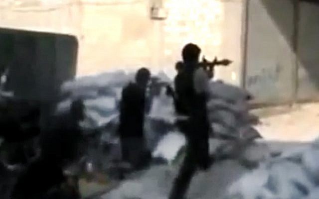 This image made from amateur video accessed on Monday by AP purports to show Syrian rebels firing on government troops in Damascus (photo credit: AP/Ugarit News)