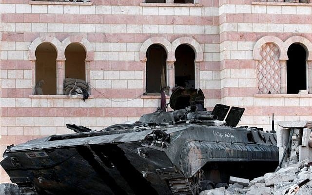 A damaged Syrian military tank is seen in the border town of Azaz, some 20 miles (32 kilometers) north of Aleppo, Syria, on Tuesday (photo credit: AP/Turkpix) A damaged Syrian military tank is seen in the border town of Azaz, some 20 miles (32 kilometers) north of Aleppo, Syria, on Tuesday (photo credit: AP/Turkpix)