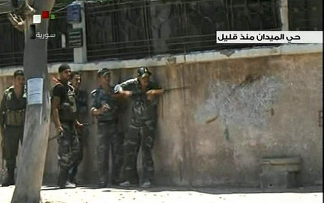 Syrian troops clash with rebels in Damascus' Midan neighborhood in July 2012. (AP Photo/SANA via AP video) Syrian troops clash with rebels in Damascus' Midan neighborhood in July 2012. (AP Photo/SANA via AP video)
