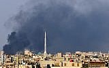 In this citizen journalist image, smoke billows over Damascus, Syria, in July (photo credit: AP)