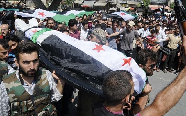 Syrians on Friday carry the body of an individual killed during clashed in Aleppo (photo credit: AP/Alberto Prieto)