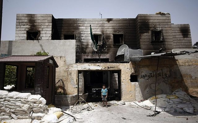 A Syrian boy stand in the rubble of a destroyed police station at the border town of Azaz, some 20 miles (32 kilometers) north of Aleppo, Syria. (Turkpix/AP)