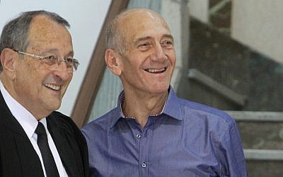 Ehud Olmert, right, and his lawyer, Eli Zohar, after he was cleared of several corruption charges in July (photo credit: Miriam Alster/Flash90)