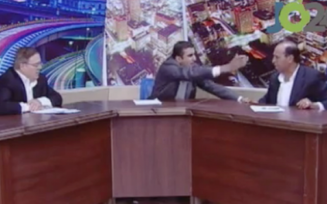 A heated debate on Jordan TV between an MP (right) and an activist (left) deteriorated into a brawl in which a gun was drawn. (photo credit: YouTube screen capture) A heated debate on Jordan TV between an MP (right) and an activist (left) deteriorated into a brawl in which a gun was drawn. (photo credit: YouTube screen capture)