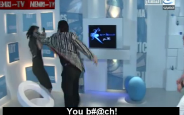 Ayman Kandeel fells the woman he thinks is an Israeli TV host. (photo credit: MEMRI screenshot) Ayman Kandeel fells the woman he thinks is an Israeli TV host. (photo credit: MEMRI screenshot)
