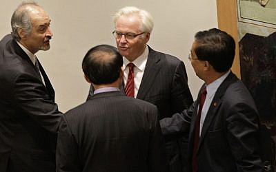 Syria's U.N. Ambassador Bashar Ja'afari, left, thanks a member of the Chinese UN delegation as China's UN Ambassador Li Baodong, second from right, and Russia's U.N. Ambassador Vitaly Churkin look on, after a Security Council meeting on the situation in Syria at the United Nations in New York, Thursday. (photo credit: AP)