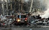 A fire engine at Manhattan's collapsed World Trade Center following the terror attack on September 11, 2001. (photo credit: CC BY-SA 3.0, by Chief Photographer's Mate Eric J. TIlford/US Navy, Wikimedia Commons)
