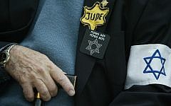 An unidentified Holocaust survivor sits holding his cane in the Yad Vashem Holocaust Memorial complex in Jerusalem (photo credit: Pierre Terdjman/Flash90)