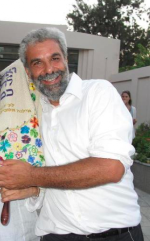 Rabbi Roberto Arbib, moving one of the Torah scrolls into the new synagogue (Courtesy Rabbi Roberto Arbib)