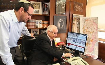 Knesset Speaker Reuven Rivlin (seated) cuts a 'virtual red ribbon' inaugurating the Knesset's updated website (photo credit: Knesset spokesperson)