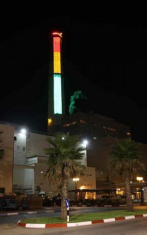 The Reading power plant lit up with the national power consumption graph. (photo credit: Chen Leopold/Energy Ministry)