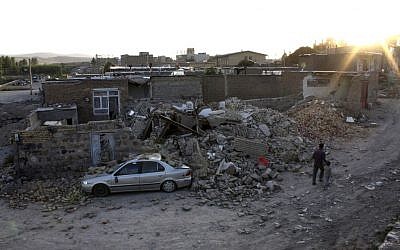 Ruins of a houses are seen after an earthquake in the city of Varzaqan in northwestern Iran, on Saturday. (photo credit: AP/Mehr News Agency, Hamed Nazari)