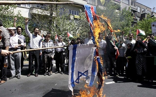 Iranian demonstrators burn an Israeli and British flag during a rally marking Quds Day, on the last Friday of Ramadan, in Tehran last year. (photo credit: AP/Vahid Salemi) Iranian demonstrators burn an Israeli and British flag during a rally marking Quds Day, on the last Friday of Ramadan, in Tehran last year. (photo credit: AP/Vahid Salemi)