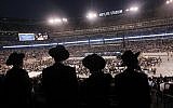 Ultra-Orthodox Jews celebrating the Siyyum Hashas, or end of the 7.5 year Talmud learning cycle, in New Jersey's MetLife Field Wednesday night. (photo credit: AP/ Mel Evans)
