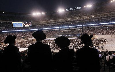 Ultra-Orthodox Jews celebrating the Siyyum Hashas, or end of the 7.5 year Talmud learning cycle, in New Jersey's MetLife Field Wednesday night. (photo credit: AP/ Mel Evans)