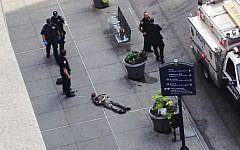 New York City police approach the lifeless body of Jeffrey Johnson lying on a sidewalk near the Empire State Building in New York following a shooting on Friday, August 24. (photo credit: AP/Guillermo Ratzlaff)