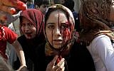Injured Syrian women arrive at a field hospital after an air strike hit their homes in the town of Azaz on the outskirts of Aleppo, Syria, Wednesday, Aug. 15, 2012. (photo credit: Khalil Hamra/AP)