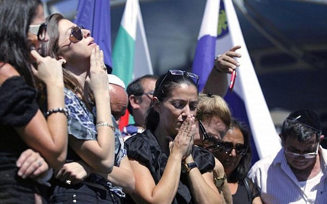 Relatives of five Israeli victims of a suicide bomber who targeted a bus of Israeli tourists a month earlier, mourn during a commemoration ceremony at Burgas airport. (photo credit: AP)