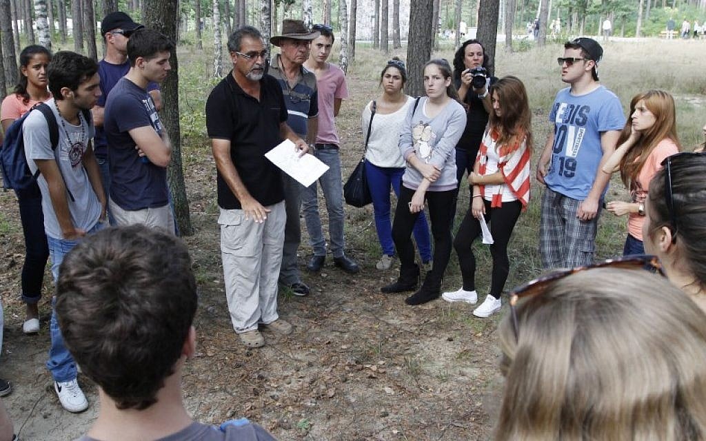 Archaeologist Yoram Haimi talking to young people from the Dror School in Israel about his findings at the site of the former German Nazi death camp of Sobibor, in eastern Poland, on Tuesday, Aug. 21, 2012 (photo credit: AP/Czarek Sokolowski) Archaeologist Yoram Haimi talking to young people from the Dror School in Israel about his findings at the site of the former German Nazi death camp of Sobibor, in eastern Poland, on Tuesday, Aug. 21, 2012 (photo credit: AP/Czarek Sokolowski)