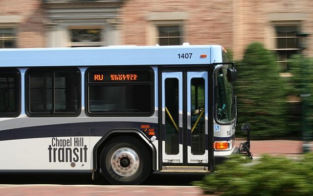 Chapel Hill Transit bus driving by a building at the University of North Carolina (photo credit: CC BY-SA 3.0, by Specious, Wikimedia Commons) Chapel Hill Transit bus driving by a building at the University of North Carolina (photo credit: CC BY-SA 3.0, by Specious, Wikimedia Commons)